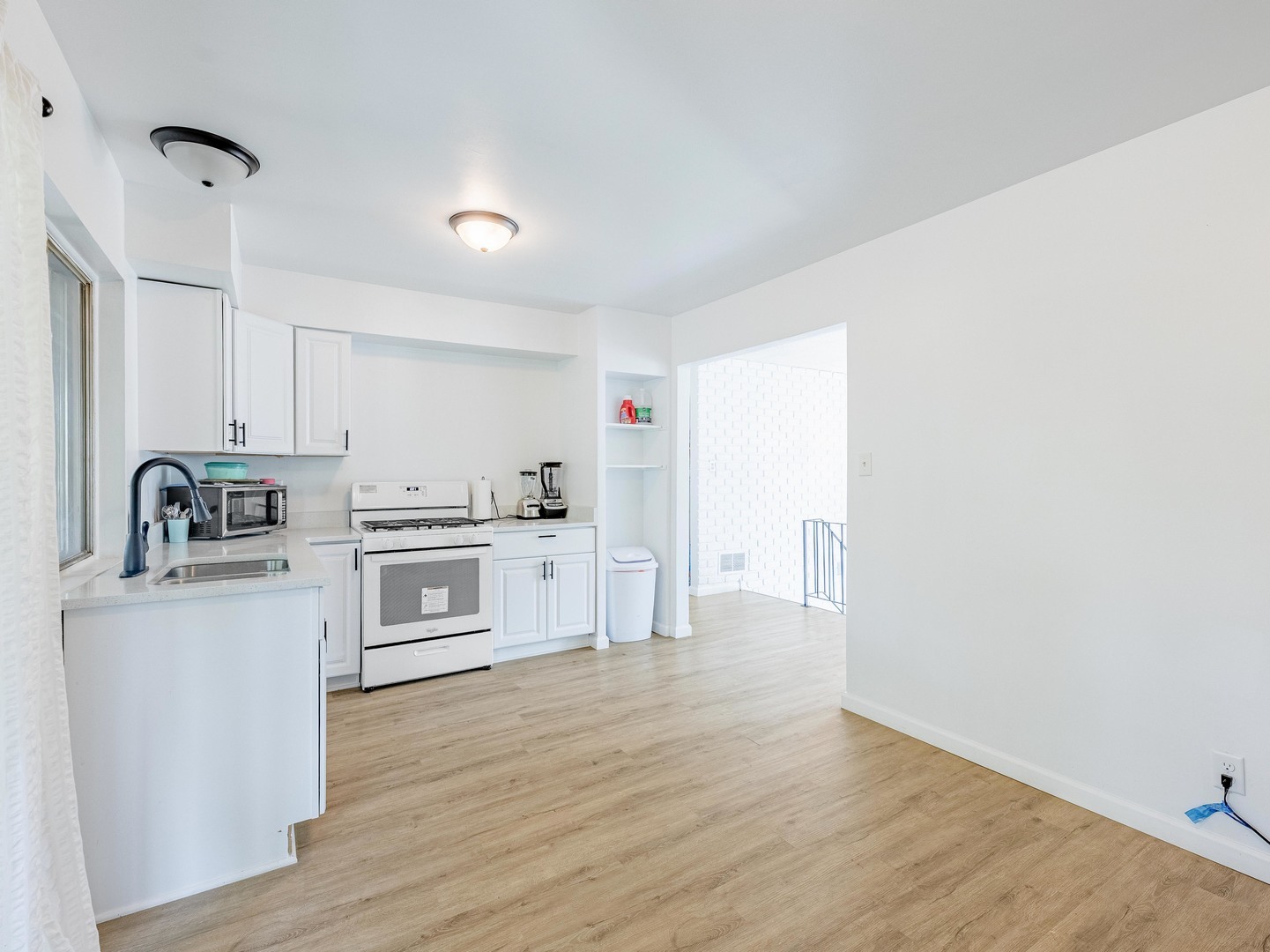 228 Riverside Drive Bolingbrook, IL 60440 - Photo 6 of 22 a kitchen with stainless steel appliances white cabinets and wooden floor