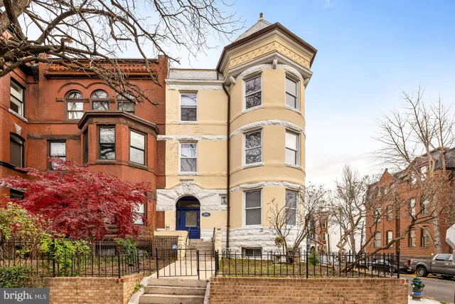 a front view of a residential apartment building with a yard