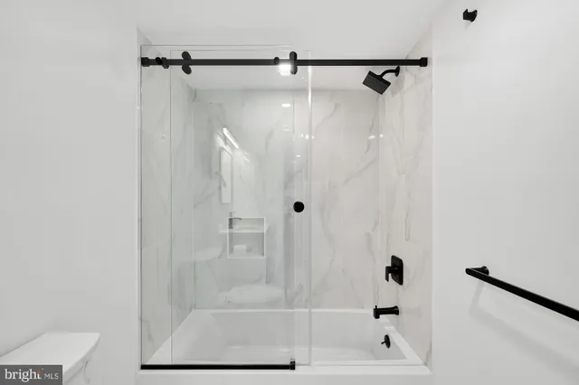 a bathroom with a glass shower door