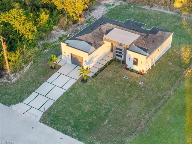 an aerial view of a house with a yard