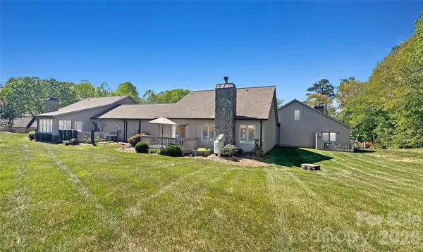 a kitchen with granite countertop sink stove and dining table