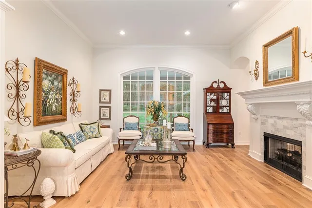 a bedroom with a large bed a flat screen tv and a large window