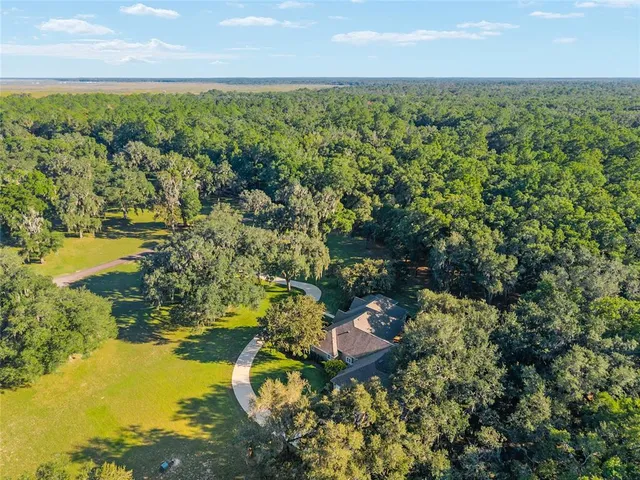 a kitchen with a refrigerator sink and cabinets