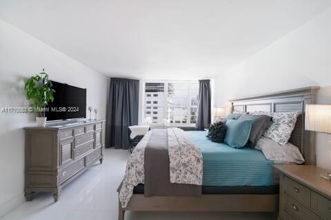 100 Lincoln Road, Unit 739 Miami Beach, FL 33139 - Photo 11 of 33 a bedroom with a large bed and a flat screen tv