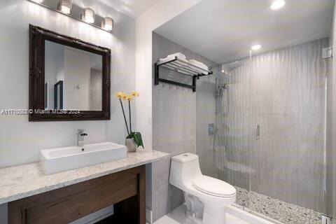 100 Lincoln Road, Unit 739 Miami Beach, FL 33139 - Photo 13 of 33 a bathroom with a toilet sink and mirror