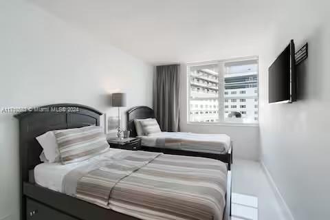 100 Lincoln Road, Unit 739 Miami Beach, FL 33139 - Photo 15 of 33 a bedroom with a bed and a flat tv screen on a dresser