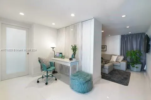 a living room with furniture and potted plant