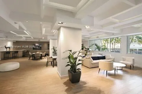 a living room with furniture and potted plant