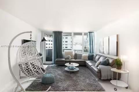 100 Lincoln Road, Unit 739 Miami Beach, FL 33139 - Photo 4 of 33 a living room with furniture and a large window