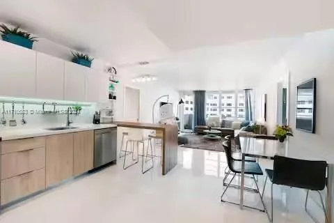 a kitchen with cabinets and chairs