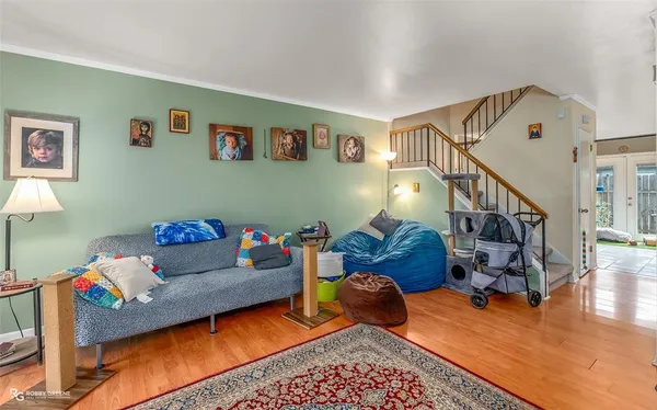 a living room with furniture and stairs