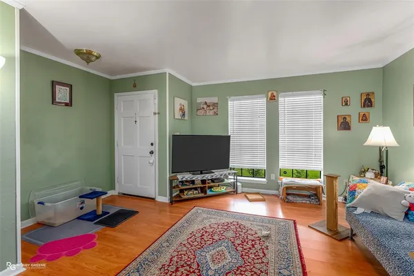 a living room with furniture and a flat screen tv