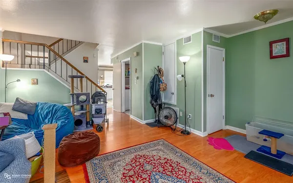a bedroom with furniture and a wooden floor