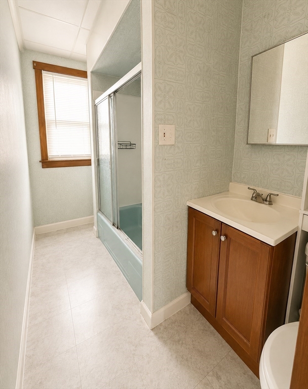 37 Shawmut Street Fall River, MA 02720 - Photo 9 of 16 a bathroom with a sink a mirror and a shower