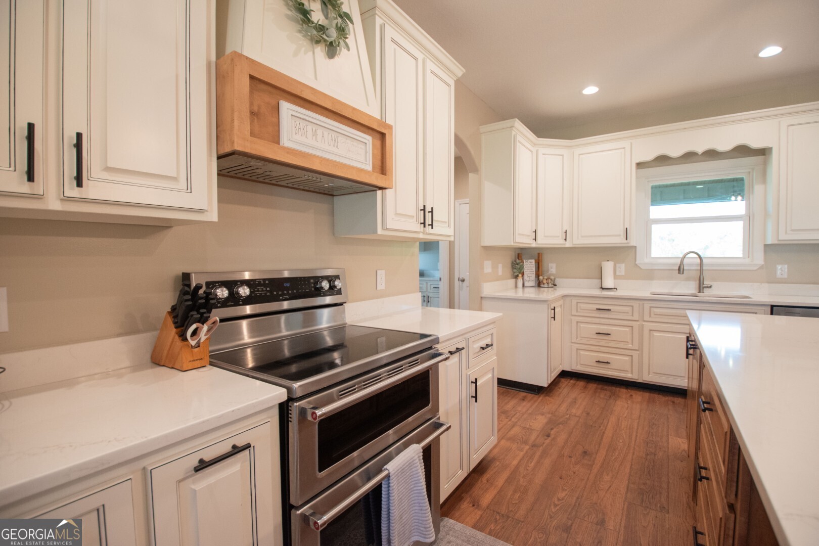 6213 Spanish Creek Road Folkston, GA 31537 - Photo 17 of 38 a kitchen with stainless steel appliances a white stove top oven sink and cabinets