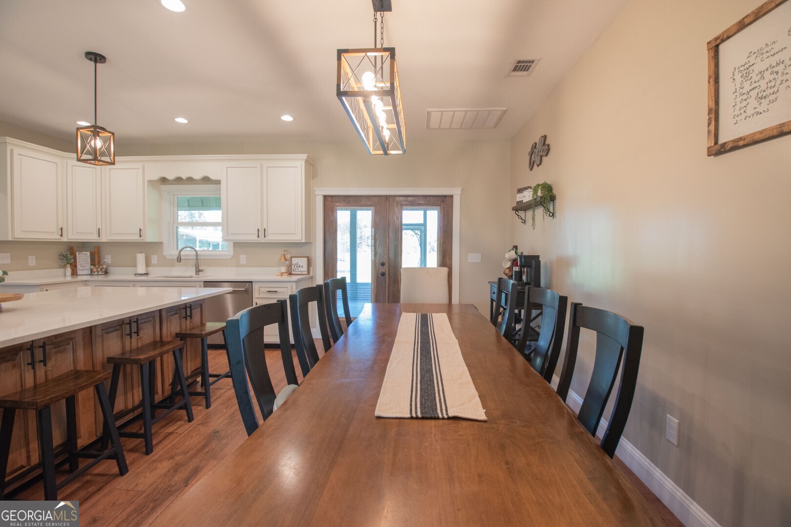 6213 Spanish Creek Road Folkston, GA 31537 - Photo 18 of 38 a dining room with wooden floor and large windows