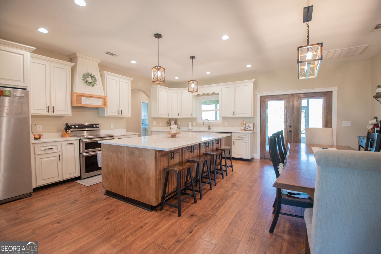 6213 Spanish Creek Road Folkston, GA 31537 - Photo 22 of 38 a large kitchen with stainless steel appliances lots of counter space a sink refrigerator and cabinets
