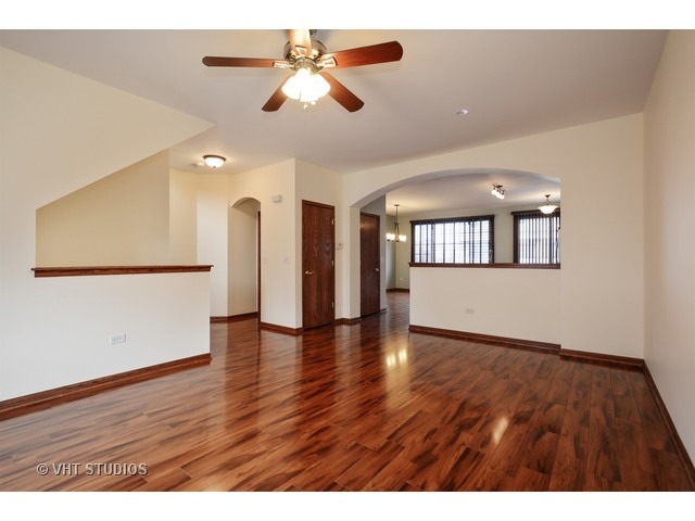 15646 Scotsglen Road Orland Park, IL 60462 - Photo 3 of 14 an empty room with wooden floor and windows