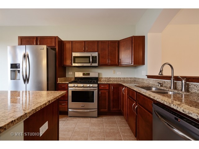 15646 Scotsglen Road Orland Park, IL 60462 - Photo 4 of 14 a kitchen with stainless steel appliances granite countertop a sink stove and refrigerator