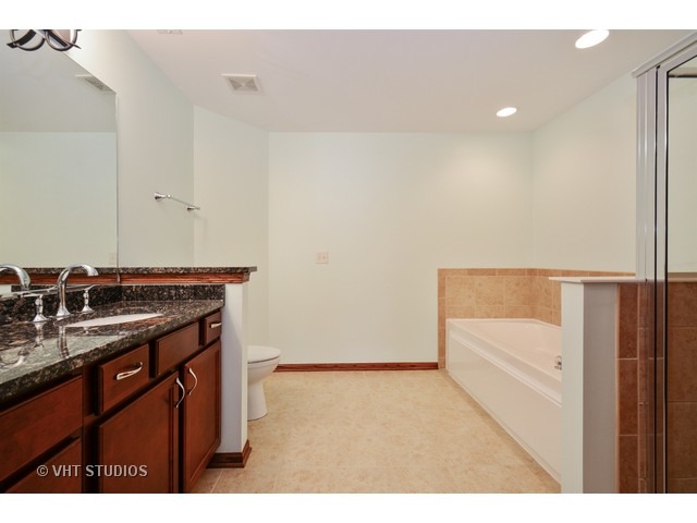 15646 Scotsglen Road Orland Park, IL 60462 - Photo 8 of 14 a kitchen with a sink and a refrigerator