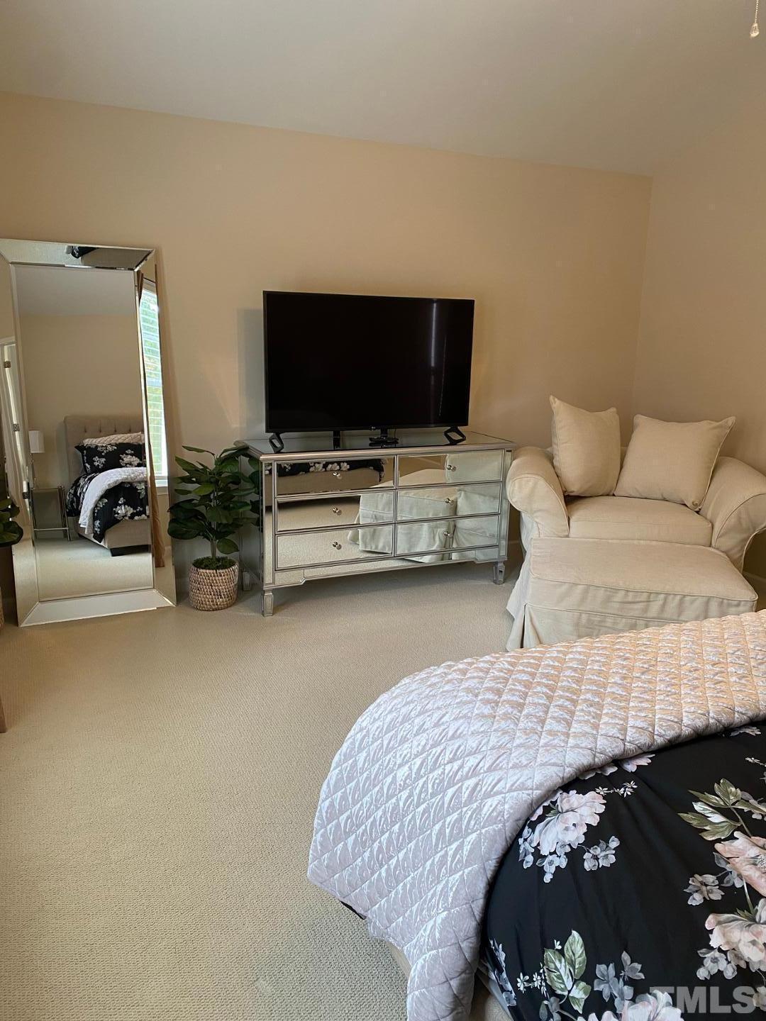 6006 McDevon Drive Raleigh, NC 27617 - Photo 12 of 12 a living room with furniture and a flat screen tv
