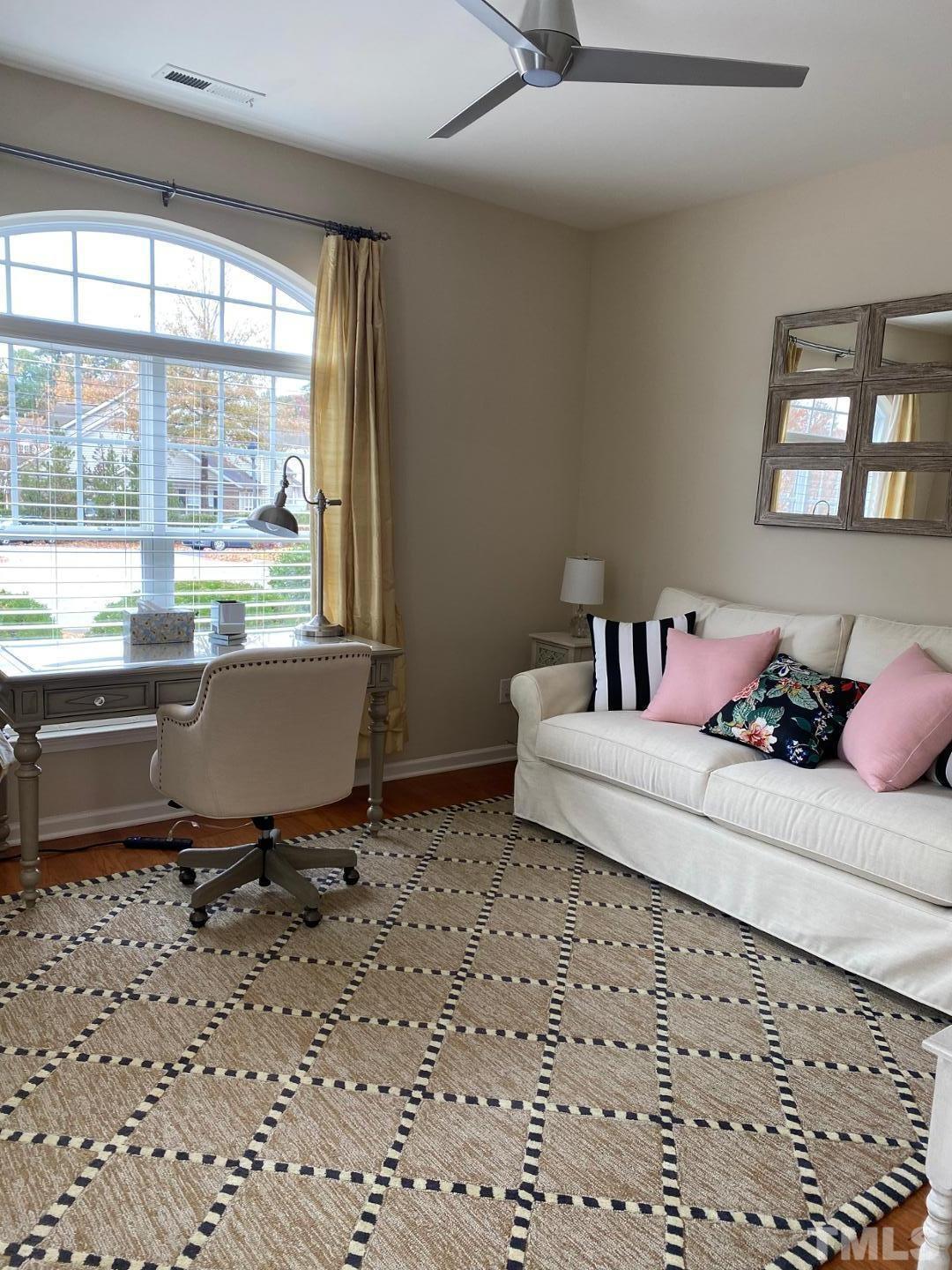 6006 McDevon Drive Raleigh, NC 27617 - Photo 6 of 12 a living room with a couch and a window