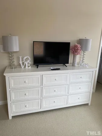 a living room with cabinets and flat screen tv