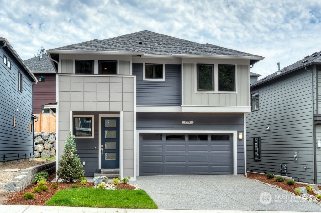2204 229th Place Southwest, Unit 26 Bothell, WA 98021 - Photo 1 of 1 a front view of a house with a yard