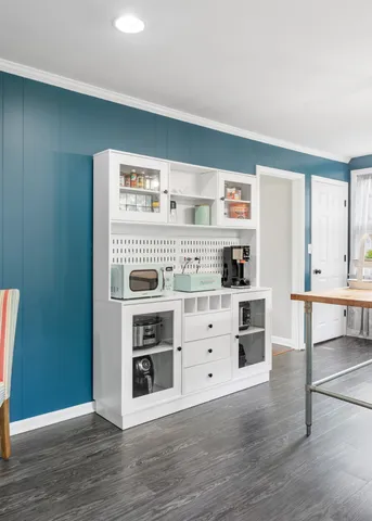 a view of kitchen with stainless steel appliances cabinets and wooden floor