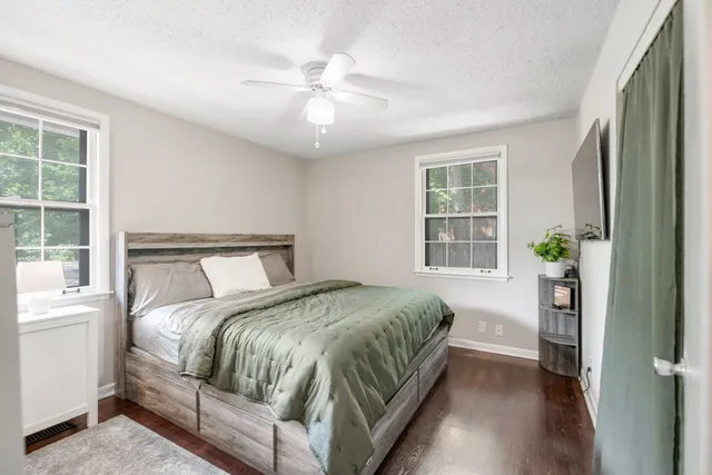 a bedroom with a large bed and a chandelier