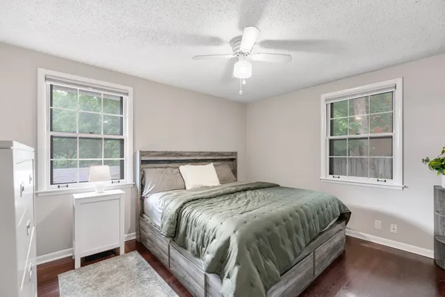 a bedroom with a large bed and a window