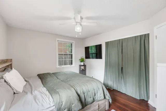 a spacious bedroom with a bed and a large window