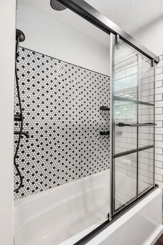 a bathroom with a bathtub and shower