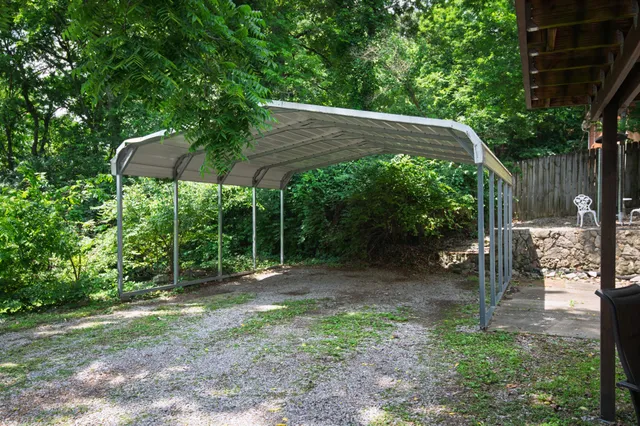 a view of a wooden deck with chairs and a yard