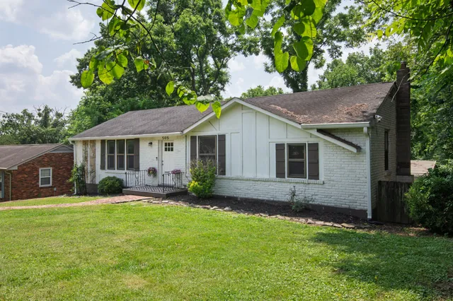 a front view of house with a garden and patio