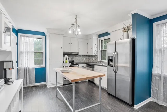 a kitchen with stainless steel appliances a refrigerator sink and stove