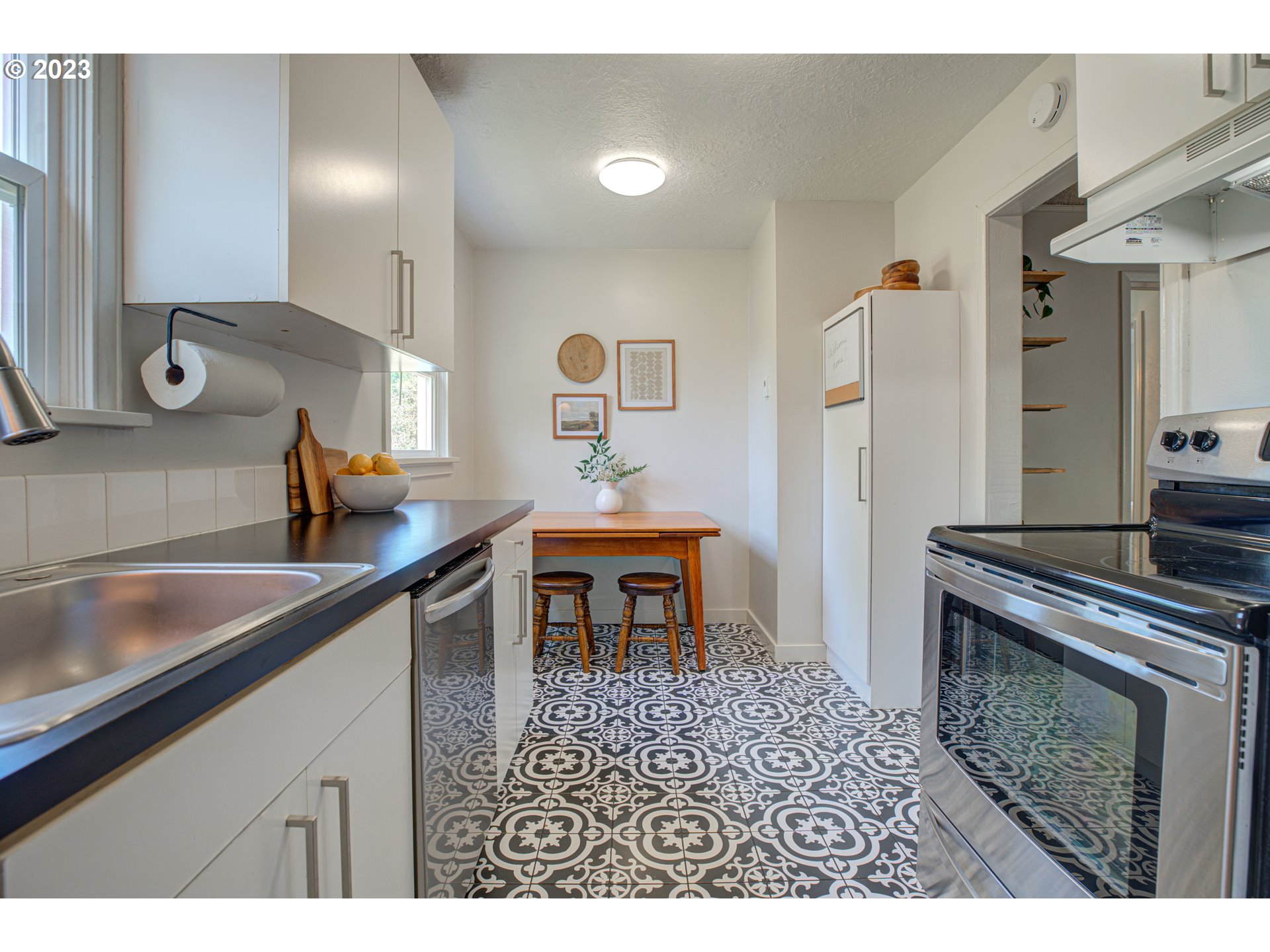100 Maple Boulevard Wood Village, OR 97060 - Photo 18 of 37 a kitchen with a sink and a refrigerator