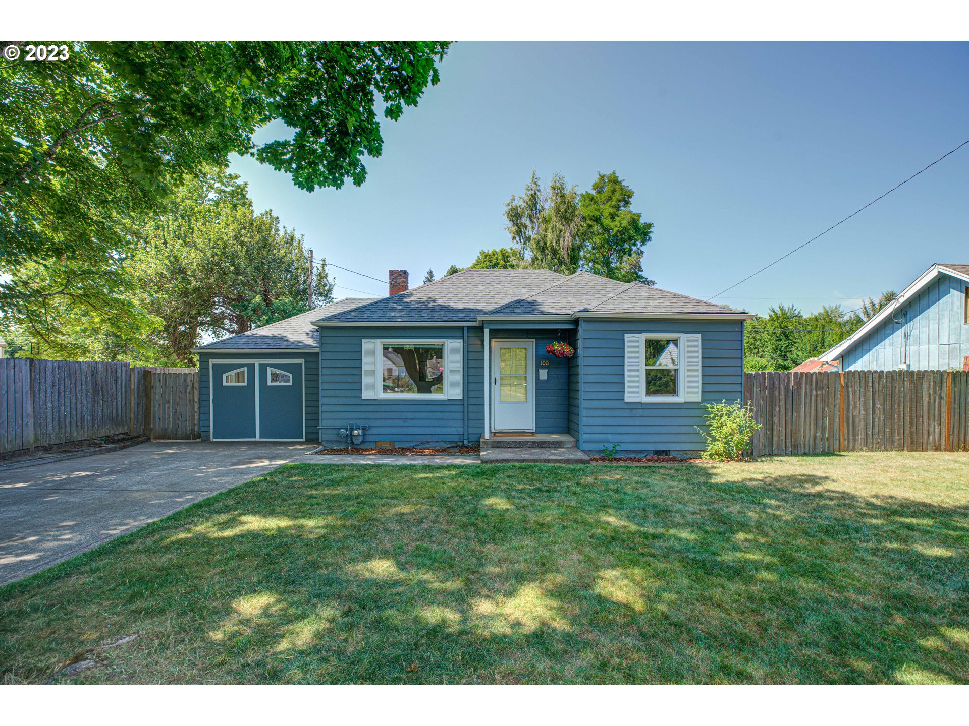 100 Maple Boulevard Wood Village, OR 97060 - Photo 2 of 37 a front view of a house with a yard and garage