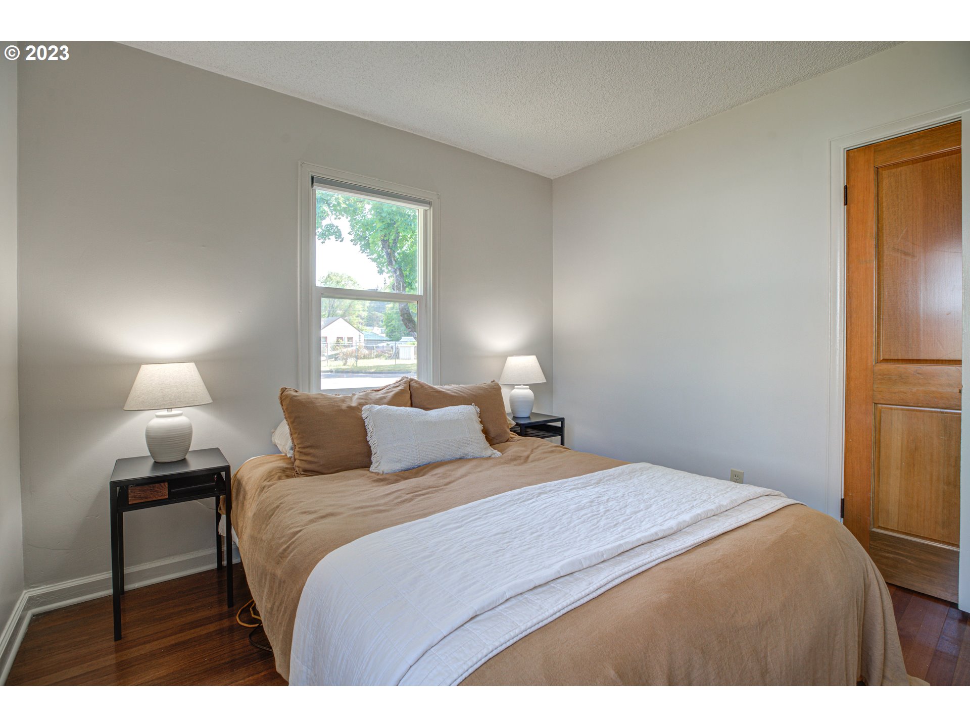 100 Maple Boulevard Wood Village, OR 97060 - Photo 21 of 37 a bedroom with a bed and a lamp
