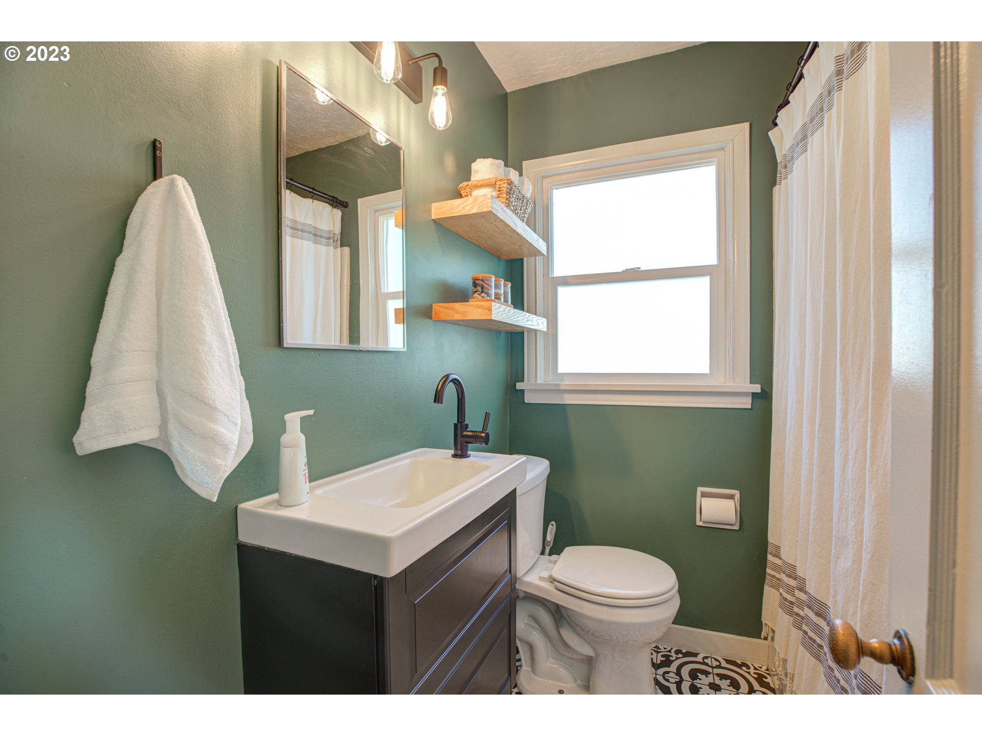 100 Maple Boulevard Wood Village, OR 97060 - Photo 25 of 37 a bathroom with a sink a toilet and a window
