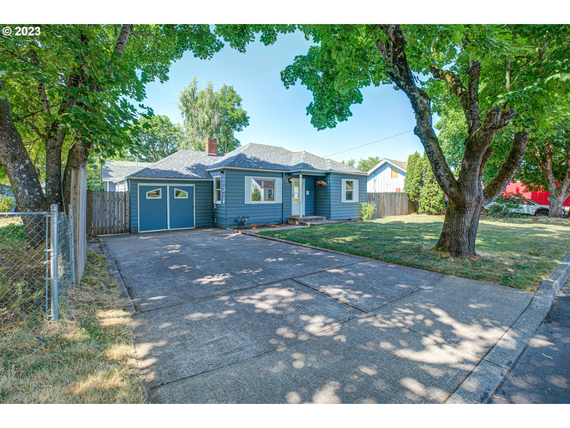 100 Maple Boulevard Wood Village, OR 97060 - Photo 5 of 37 a front view of a house with a garden and trees