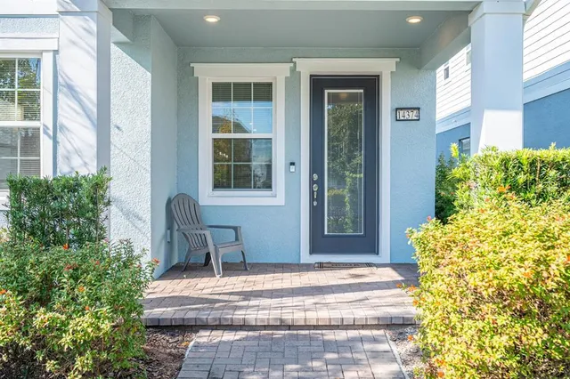 a view of a house with backyard and sitting area