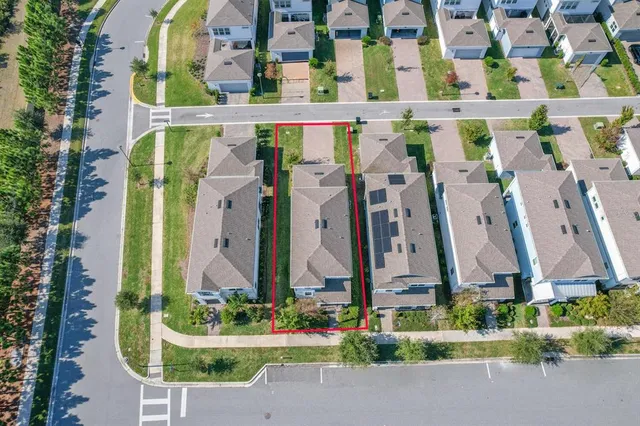 an aerial view of residential houses with outdoor space