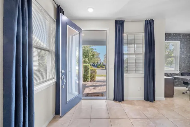 a living room with furniture and a view of kitchen