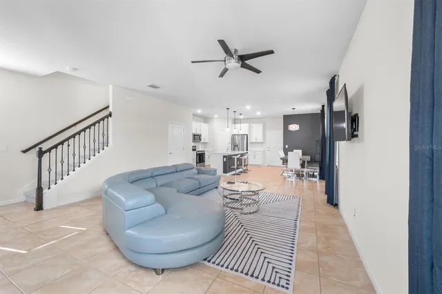 a living room with couches and a flat screen tv