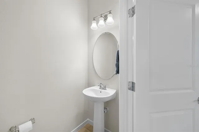 a kitchen with stainless steel appliances a stove a sink a refrigerator a center island a table and chairs