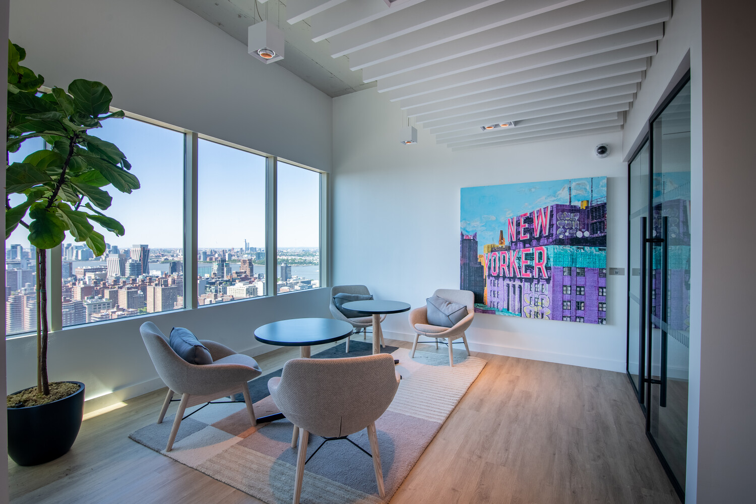 315 West 33rd Street, Unit 27F Manhattan, NY 10001 - Photo 10 of 13 a dining room with furniture a potted plant and wooden floor