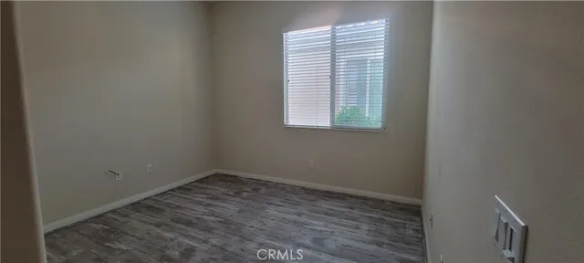 a small space with wooden floor and a window