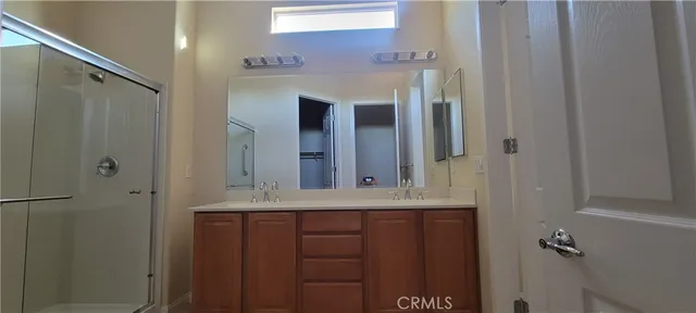 a view of a small space with wooden floor and a window