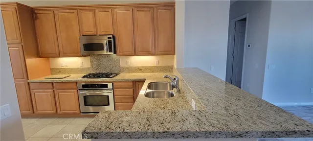 a kitchen with a sink a stove and cabinets
